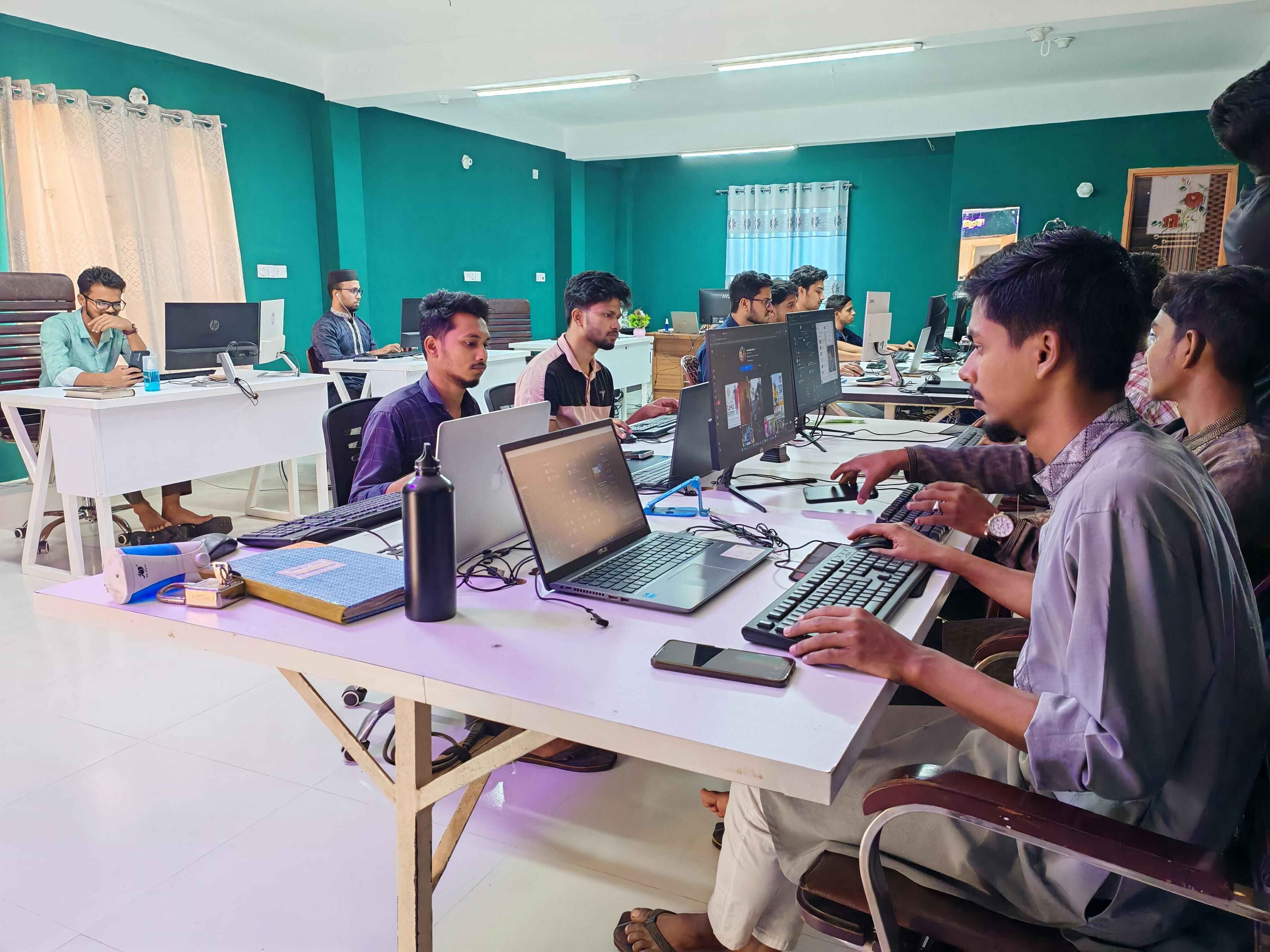 BD Commerce team working together with laptops and tablets